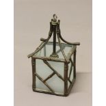 A GILT METAL HANGING LANTERN, early 20th century, with a simulated bamboo frame, height 29cm