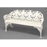 A WHITE-PAINTED GARDEN BENCH, in the Coalbrookdale style, the pierced back cast with flowering