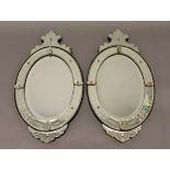 A PAIR OF VENETIAN WALL MIRRORS, of oval form, the bevelled plate within a sectional frame with