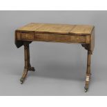 A REGENCY ROSEWOOD DROP LEAF GAMES TABLE, the shaped rectangular top with boxwood stringing and