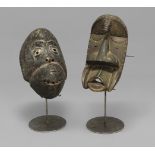 TRIBAL ART; a carved wooden mask, metal studded with exaggerated features and narrow eye slits,