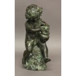 A BRONZE STUDY OF BACCHANALIAN CHERUB AND GRAPES. 19th century, modelled seated on a rocky