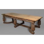 AN OAK REFECTORY TABLE, the frieze with geometric ebony and satinwood inlay, on six bulbous leaf-