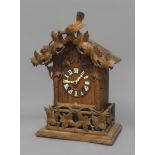 A BLACK FOREST CUCKOO CLOCK, late 19th century, the 5 1/2" dial with Roman numerals on a brass eight