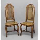 A PAIR OF CANED HALL CHAIRS, early 18th century, the carved wavy top rails above caned backs and