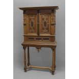 AN INLAID AND EBONISED OAK CUPBOARD, in the Aesthetic style, probably 1920s, the moulded overhanging