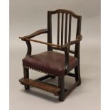 A GEORGE III MAHOGANY CHILD'S ELBOW CHAIR, with scrolling arms, leather seat and detachable and