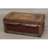 A VICTORIAN RED LEATHER CAMPHORWOOD BOX, brass mounted and studded with ring handle, enclosing a