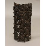 A CAST BRONZE STAND, of curved form, one side with oak leaf and acorn decoration and laurel leaves