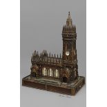 A COIN-OPERATED WOODEN SCALE MODEL OF A CHURCH, with carved turrets and spires and inlaid