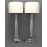 A LARGE PAIR OF CORINTHIAN COLUMN STANDARD LAMPS, the fluted columns on stepped, square bases and