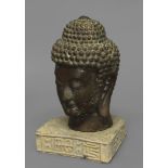 A SINO-TIBETAN BRONZE STUDY OF THE BUDDHA SHAKYAMUNI, height 28cm; on a partial stone base with