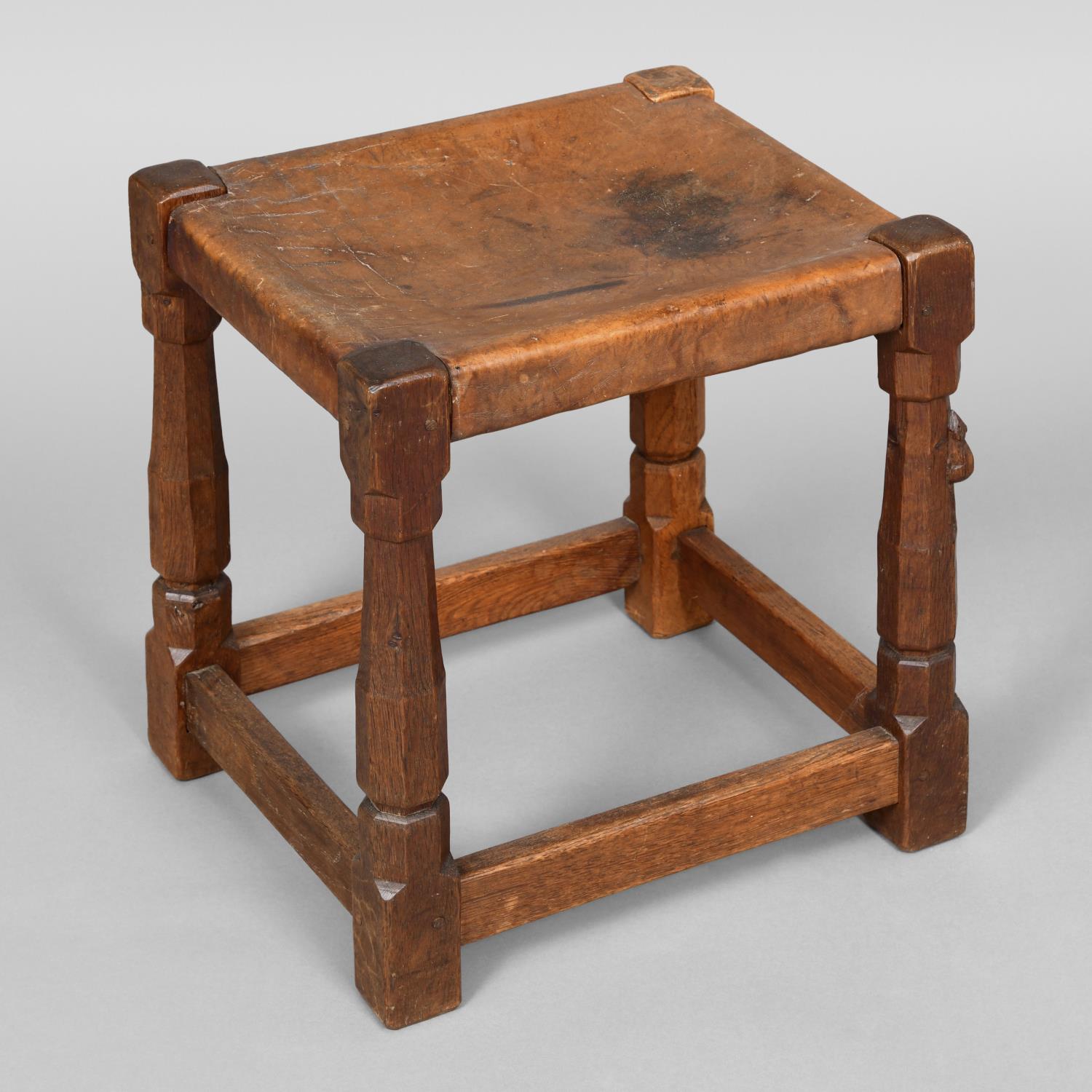 ROBERT THOMPSON OF KILBURN - EARLY MOUSEMAN STOOL. An oak stool with a solid leather seat and