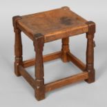 ROBERT THOMPSON OF KILBURN - EARLY MOUSEMAN STOOL. An oak stool with a solid leather seat and