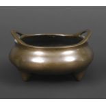 CHINESE BRONZE CENSOR. Probably 18th century, the bronze censor with raised loop handles and