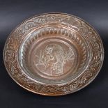 LARGE ARTS & CRAFTS EMBOSSED COPPER DISH. In the manner of John Pearson, the large dish with a