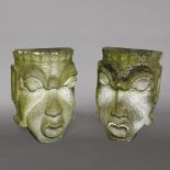 A PAIR OF COMPOSITE STONE FACES.