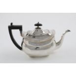 A GEORGE III TEAPOT. of rounded oblong form, with an angular handle and a wooden finial, by Samuel &