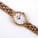 A LADY'S 9CT GOLD WRISTWATCHBY LONGINES. the signed oval-shaped dial with two Roman numerals and