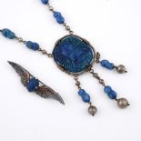 A PATE DE VERRE NECKACE. depicting a scarab, mounted in metal, the pendant 4.5cm long. **BP 22.5%