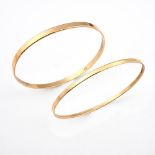 TWO 14CT GOLD BANGLES. each of plain form, internal measurements approximately 6.5cm, 22 grams. **BP