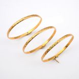 THREE GOLD BANGLES. each with engraved decoration, total weight 25.8 grams. **BP 22.5% inc VAT + Lot