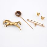 A 9CT GOLD HORSE BROOCH. designed as a leaping horse, 5cm long, 12.9 grams, together with a 9ct gold