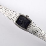A LADY'S 18CT WHITE GOLD WRISTWATCH BY OMEGA. the signed grey cushion-shaped dial with baton