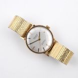 A GENTLEMAN'S GOLD AUTOMATIC WRISTWATCH BY ACCURIST. the signed circular dial with baton numerals,