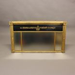 A 19TH CENTURY GILT OVERMANTEL MIRROR. in the Empire style, the triple pane mirror plate below a