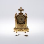 A FRENCH GILT MANTEL CLOCK. the 3 1/2" foliate dial with enamelled Roman numerals on an eight day