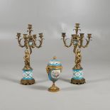 A PAIR OF 19TH CENTURY GILT AND PORCELAIN MOUNTED CANDELABRA. modelled as cherubs holding aloft,