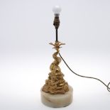 AN EARLY 20TH CENTURY GILT TABLE LAMP. in the form of a stylised dolphin on a solid circular base,