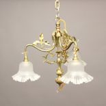 A BRASS THREE BRANCH CEILING LIGHT. of scrolling form with leaf decoration, height 43cm, width 40cm.