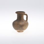 A ROMAN POTTERY GALLO JUG. circa 200AD, with flared rim and looped handle, height 13cm. * Some rim