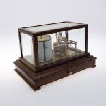 A MAHOGANY CASED BAROGRAPH. the case with bevelled glass panels and single drawer for papers, the