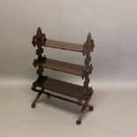 A 19TH CENTURY ROSEWOOD THREE TIER ETAGERE. in the Gothic style, with trefoil sides, carved floral