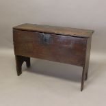AN OAK SIX PLANK COFFER. 16th century and later, the hinged top with crude border on supports carved
