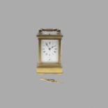 A FRENCH BRASS REPEATING CARRIAGE CLOCK. the white enamel Roman dial with subsidiary alarm dial