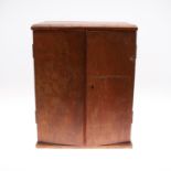 AN EALY 20TH CENTURY STAINED PINE COIN COLLECTORS CABINET.