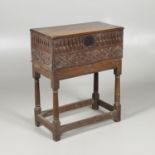 A COIN CABINET MADE FROM A SEVENTEENTH CENTURY OAK BOX ON STAND.