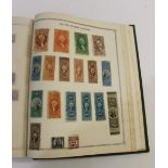 TWO STAMP ALBUMS - THE IDEAL POSTAGE STAMP ALBUM.