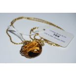 A 9CT GOLD NECKLACE SUSPENDING FACET CUT CITRINE FOB.