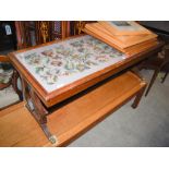 MAHOGANY COFFEE TABLE WITH GLAZED TOP CONCEALING NEEDLEWORK EMBROIDERED PANEL, RAISED ON LYRE SHAPED