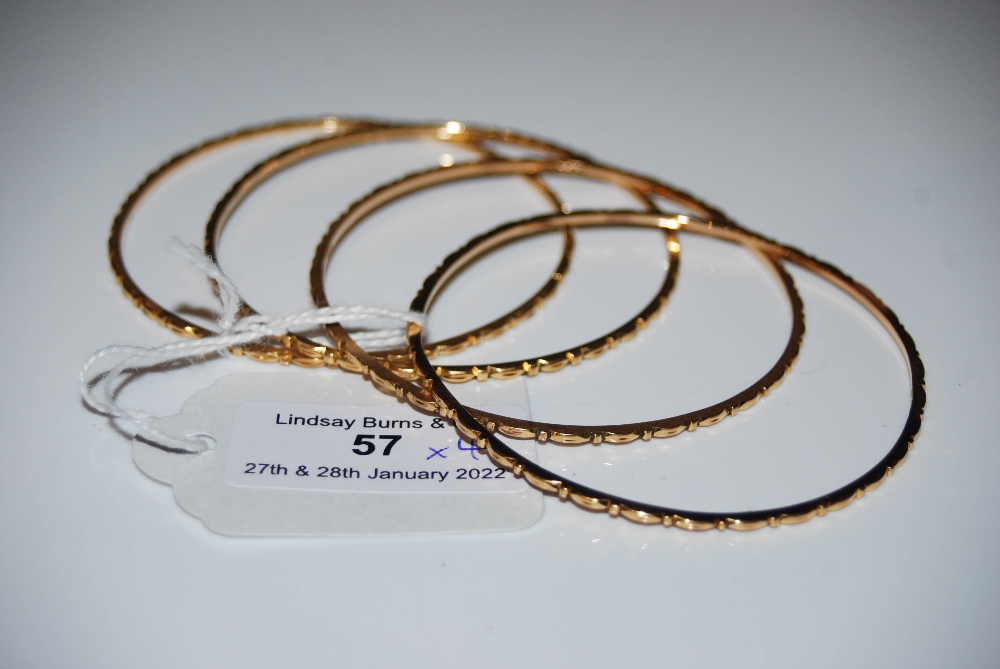 FOUR 18CT GOLD BANGLES, 32.1 GRAMS.