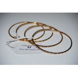 FOUR 18CT GOLD BANGLES, 32.1 GRAMS.