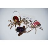 THREE DECORATIVE BROOCHES COMPRISING TWO SPIDER BROOCHES AND A BEETLE BROOCH.