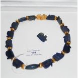 YELLOW METAL MOUNTED LAPIS LAZULI NECKLACE.