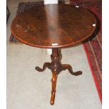 A 19TH CENTURY OAK TRIPOD SNAP-TOP OCCASIONAL TABLE, THE TOP OF ROUND FORM, FORMED BY TWO PLANKS