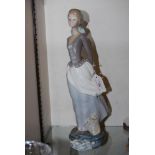 LLADRO PORCELAIN FIGURE OF GIRL HOLDING A BOOK BEHIND HER BACK.